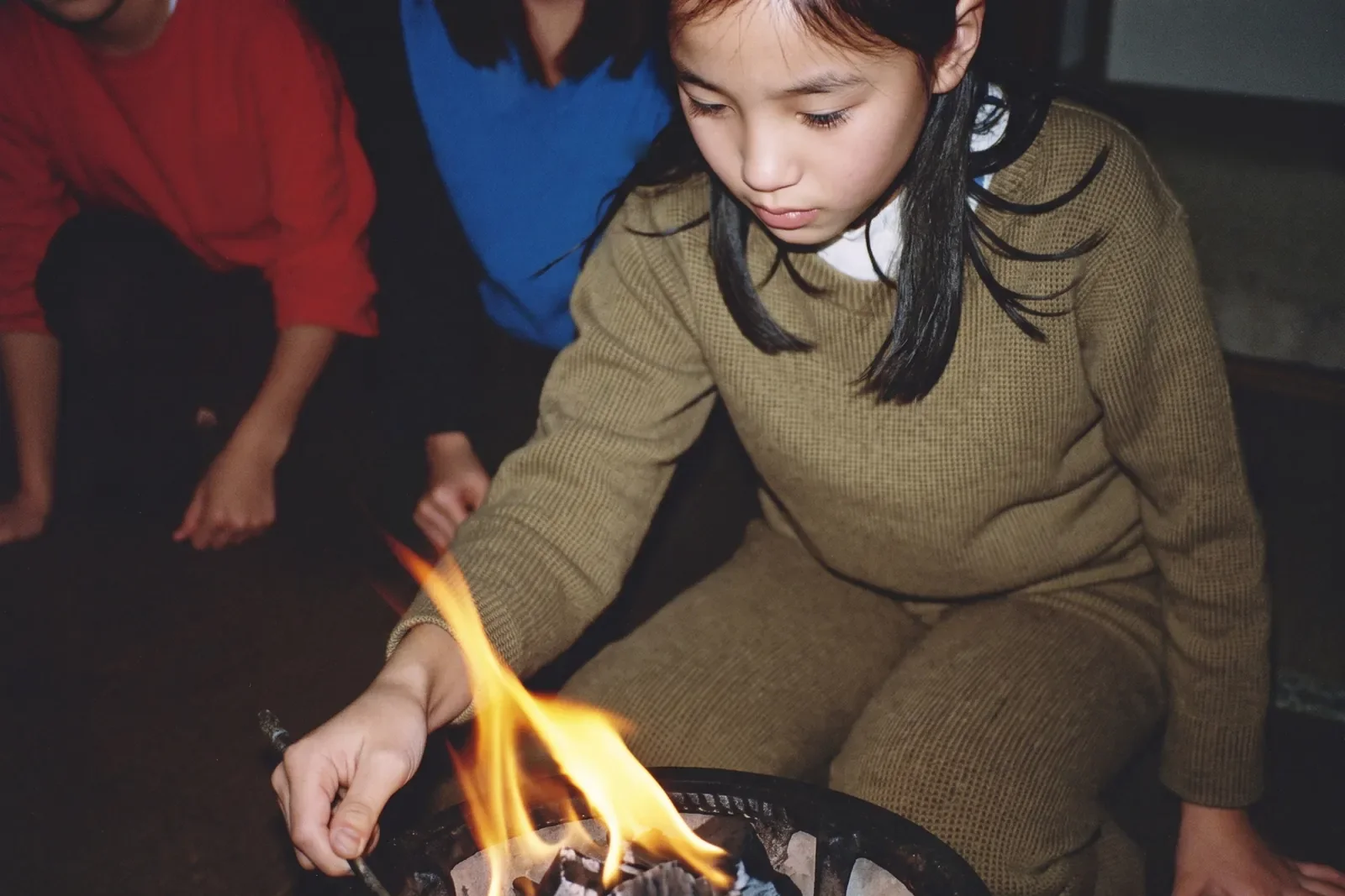 小さな火に息を吹きかける女の子