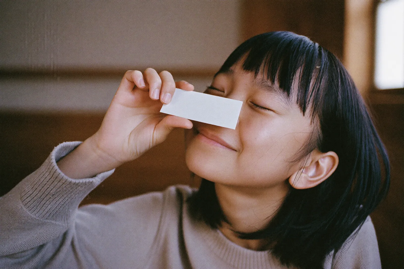 香りの紙をかぐ女の子